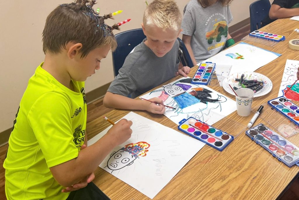 During Crazy Hair Day, Jacob U. and Hunter G. made their own crazy hair drawing with oil pastels and watercolor paint.