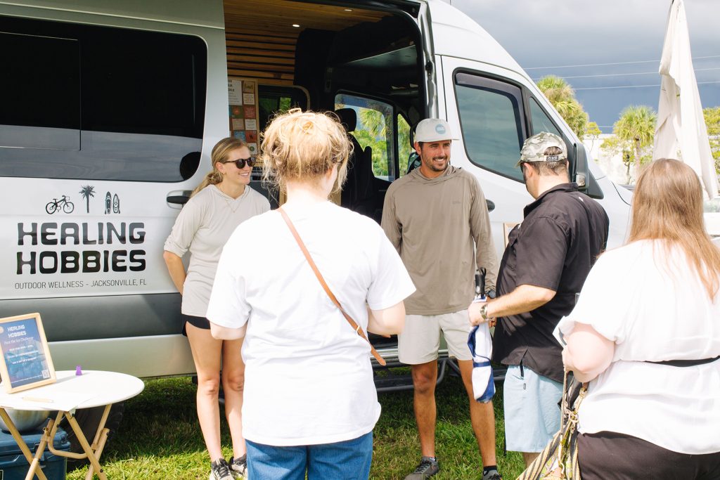 people outside of Healing Hobbies van at ECHO Fair