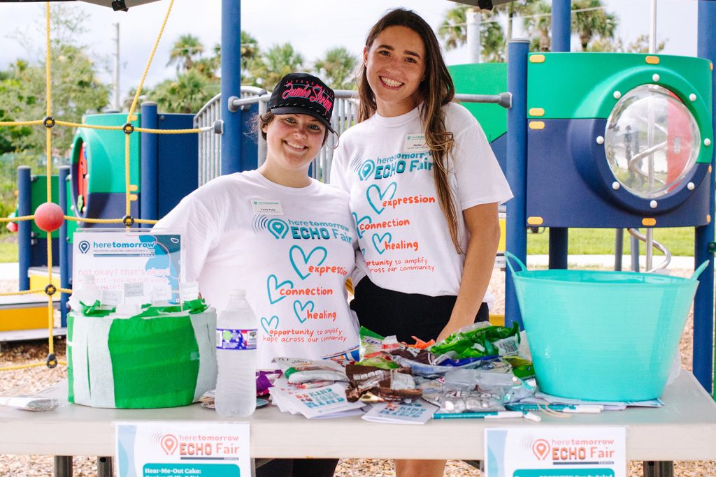 2 smiling women with ECHO Fair tshirts on