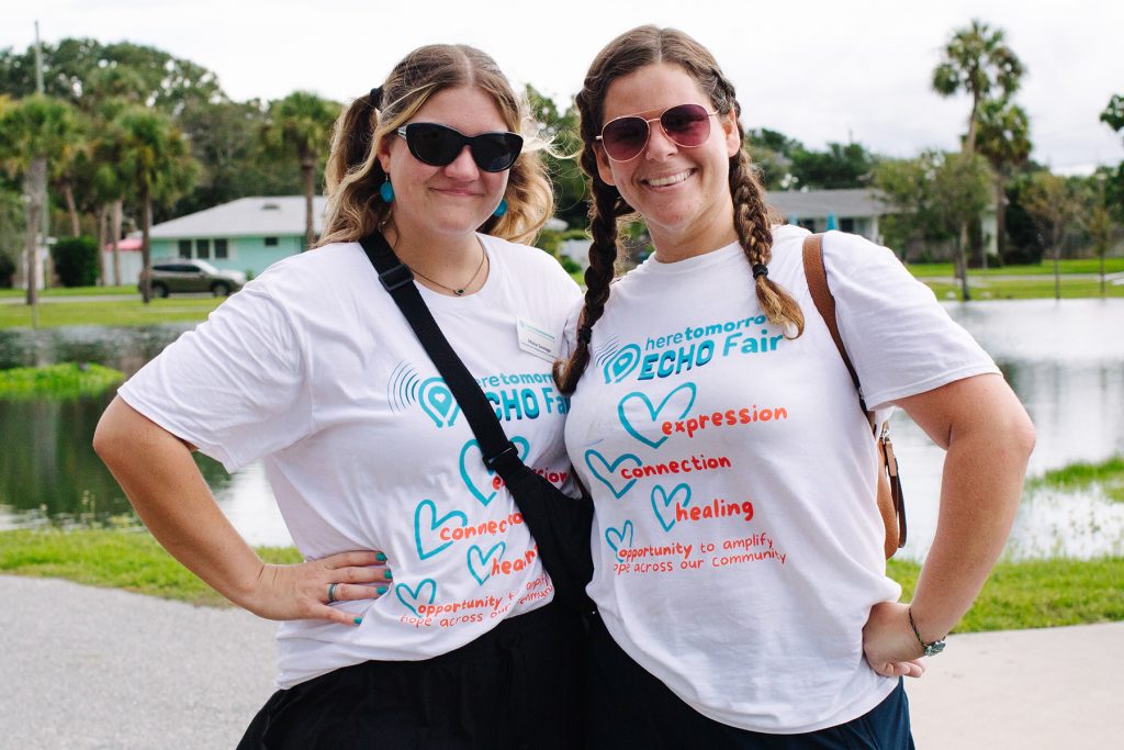2 smiling women with ECHO Fair tshirts on