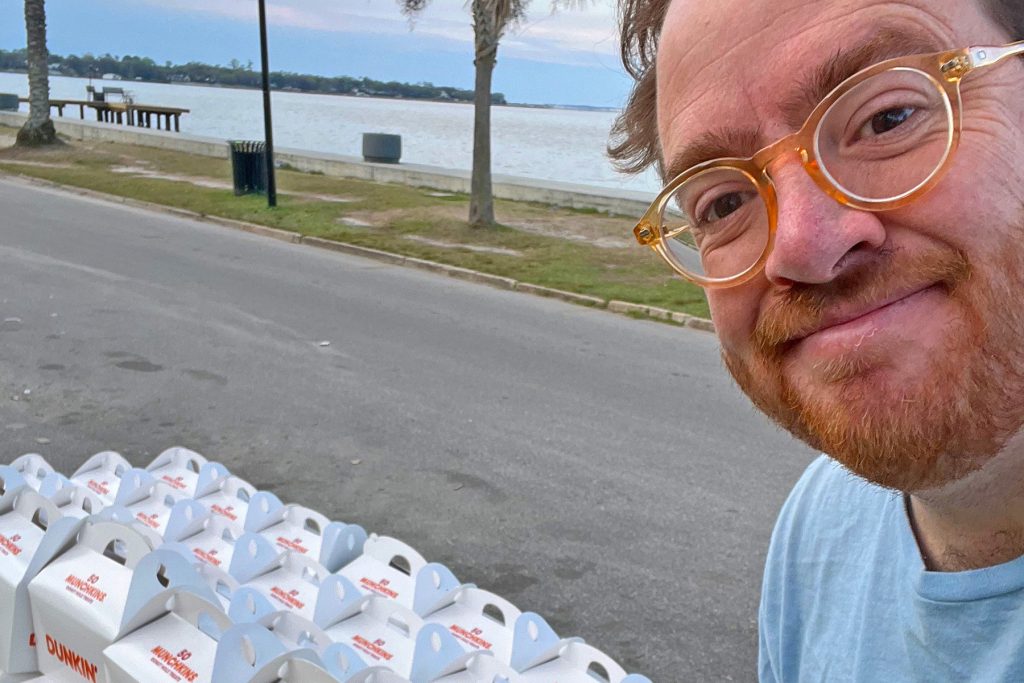 Sam Mitchell prepares to pass out donut holes for the Gate River Run.