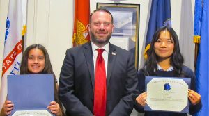 Jacksonville City Council President joins Page Leyli Amoli (left), a home school student and Page Leona Shaffer (right), a student at the Samuel Wolfson School for Advanced Studies, at the Aug. 12 city council meeting.