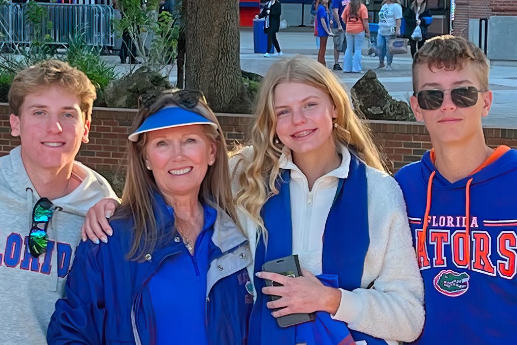Joshua and Jackson pose with their Aunt Trudy and sister Jordan at a Gators game.