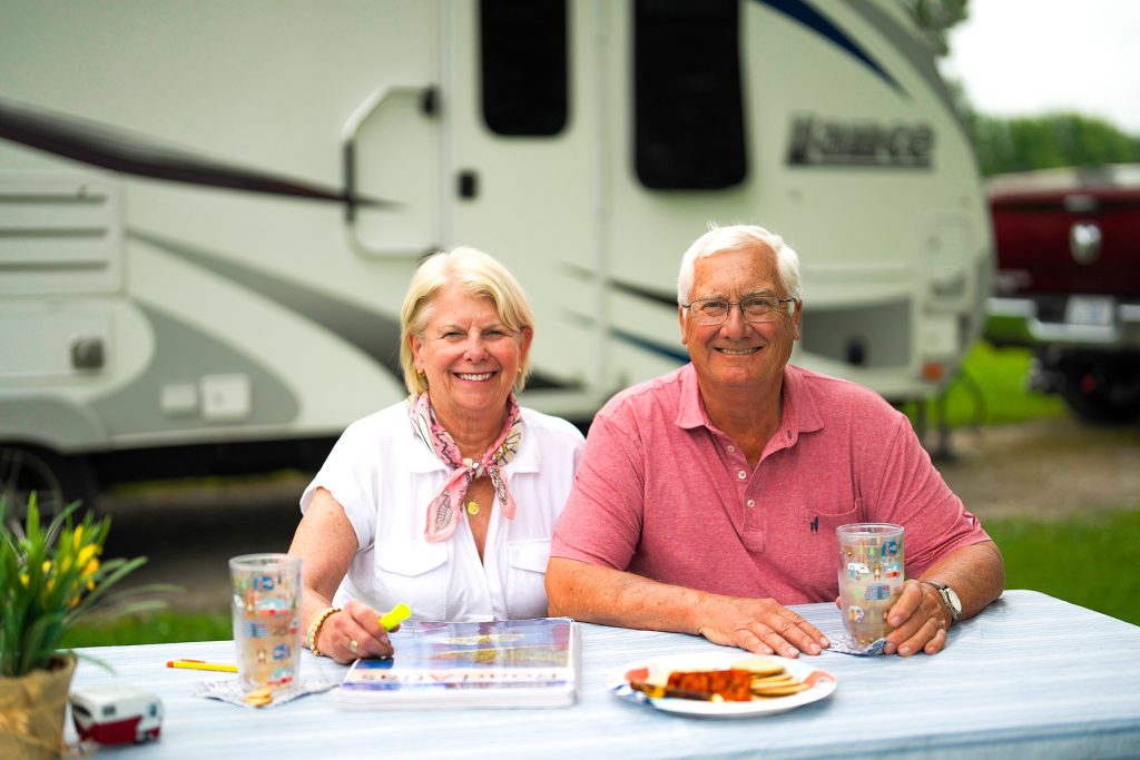 John and Brooke in front of their camper