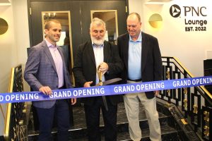 Numa Saisselin, president of the Florida Theatre, cuts the ribbon on the new PNC Lounge at the Theatre Sept. 12 as, from left, Chris Kalin, PNC regional president for North Florida, and Don Cameron, chairperson of the Board of Directors for the Florida Theatre, look on.