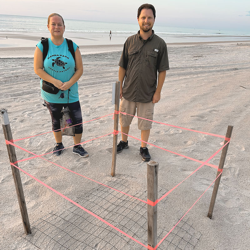 Sea Turtle Patrol 3rd year Volunteer Jamie Mixon and Stephen Klem with a protected nest.