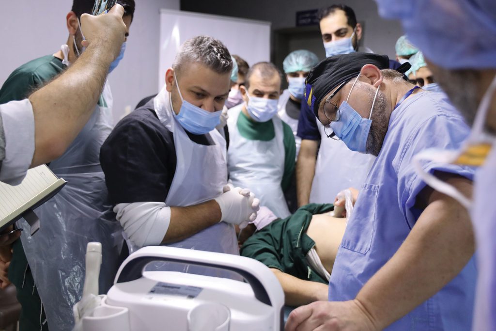 Dr. Samotowka training young surgeons in ultrasound technology