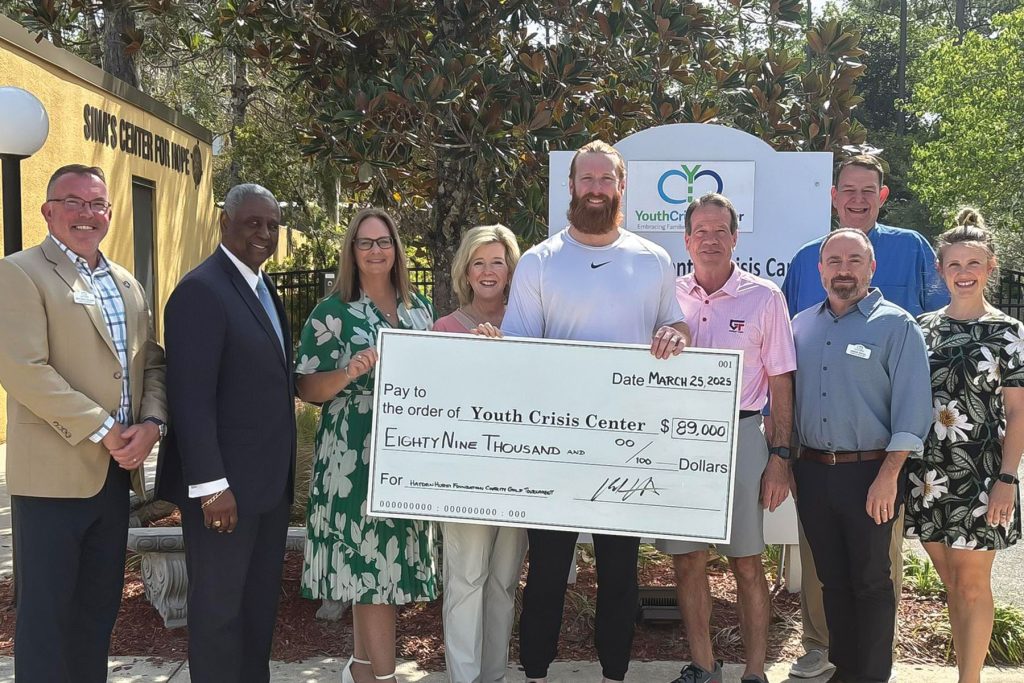 Board Members gathered alongside the Hurst family and the YCC staff in celebration of a donation from the Hayden Hurst Family Foundation