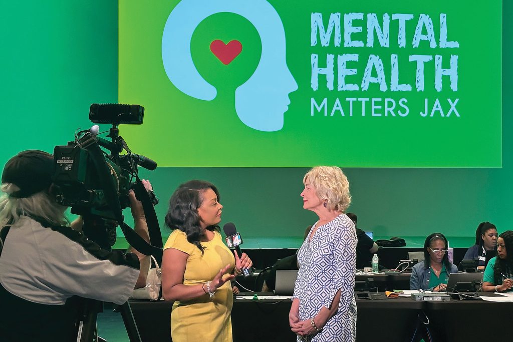 Dr. Christine Cauffield speaks with reporters from WJXT TV-4 in Jacksonville during a mental health awareness event