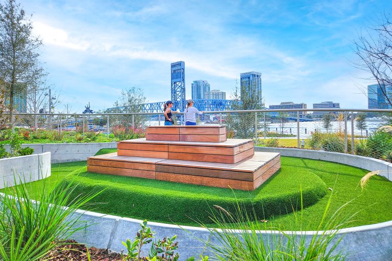 Residents take in the view from atop the playground, where a raised photo-taking platform offers sweeping views of Downtown backdrops.
