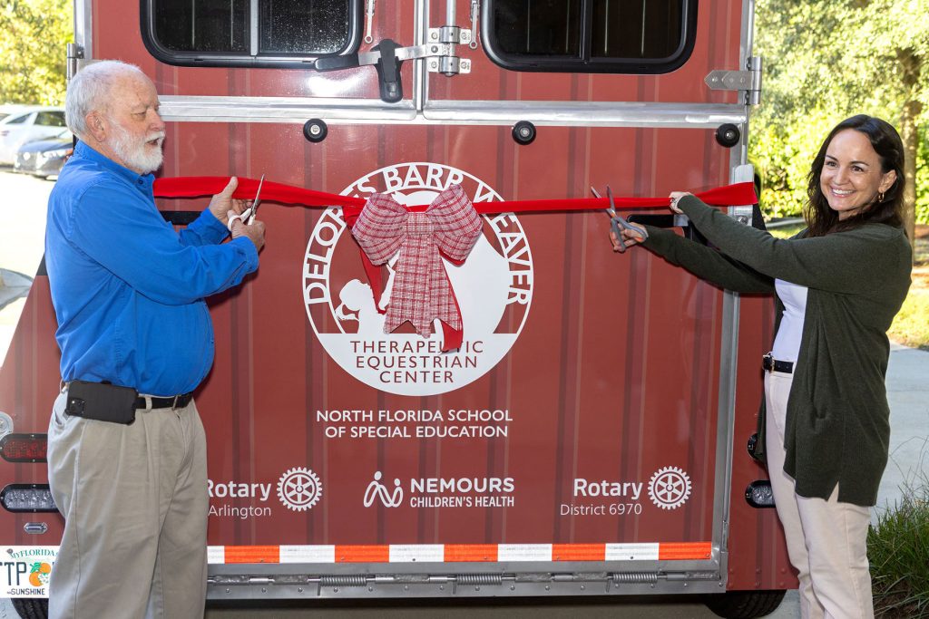 East Arlington Rotary Club President Jim Smith and Jennifer Pfieffer, Nemours Director of Assisted Dog and Pony Therapy (ADAPT), present the new horse trailer donated by the Rotary Club.