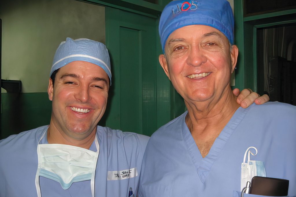 Dr. John Lovejoy, Jr. (left) poses with his son and fellow surgeon in Haiti following the earthquake of 2010