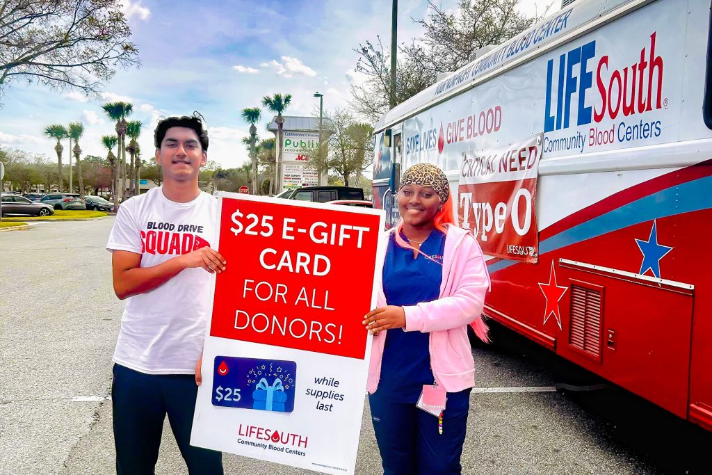 Arah is working alongside phlebotomist Tamara to recruit blood donors.