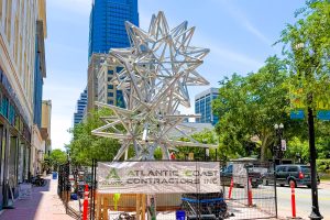 Construction crews are working to install “Jacksonville Stacked Stars” on the Laura Street sidewalk in front of MOCA in Downtown Jacksonville.