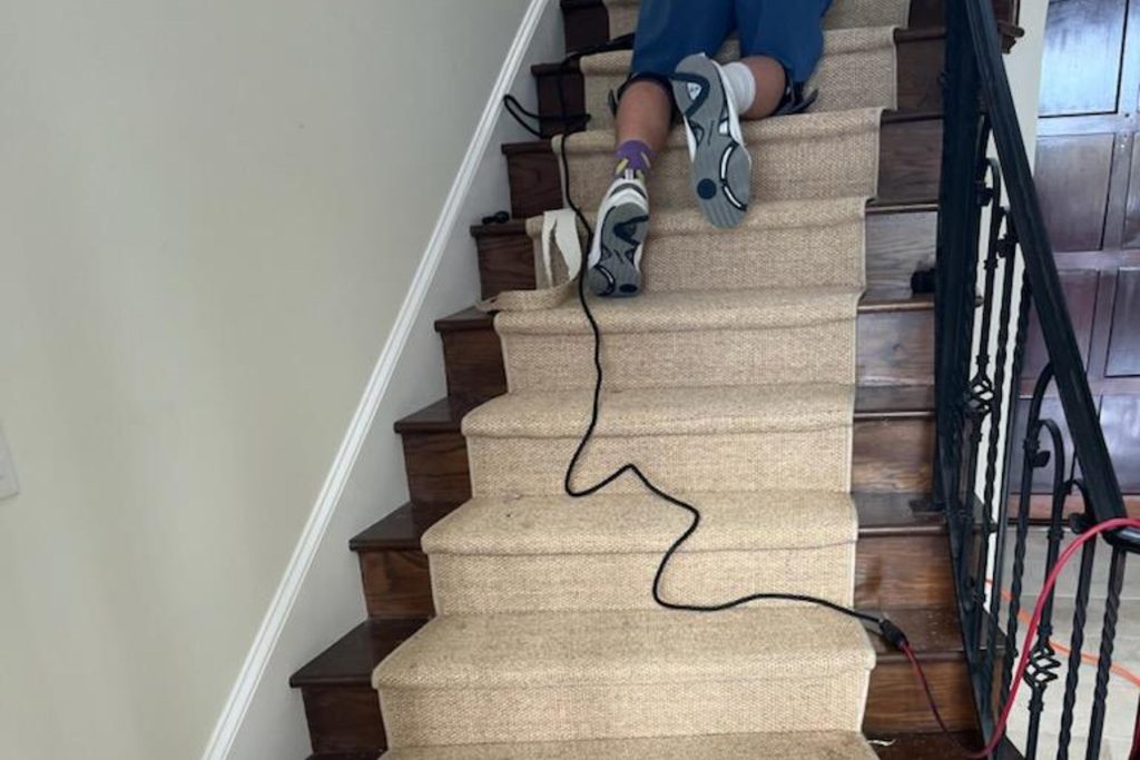 Mark Stone installing accent down staircase center.