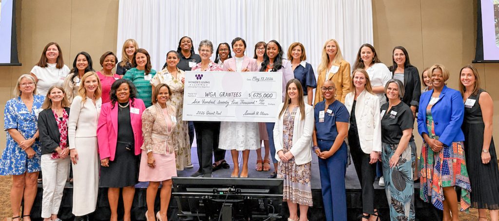 WGA President Sabeen Perwaiz stands, center, with the 2026 WGA grant recipients at the WGA Member Forum on May 19.