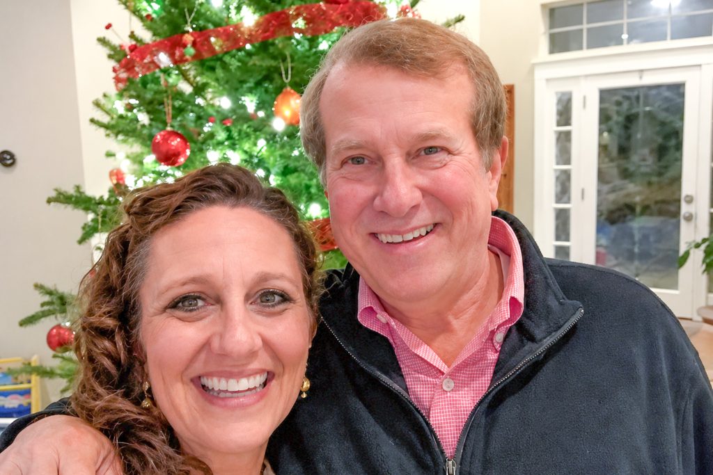 smiling with Christmas tree in background